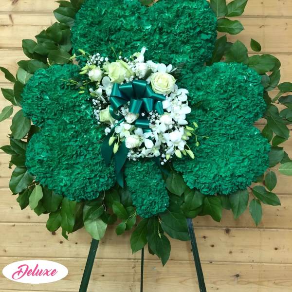 Green floral standing spray with white roses and ribbon