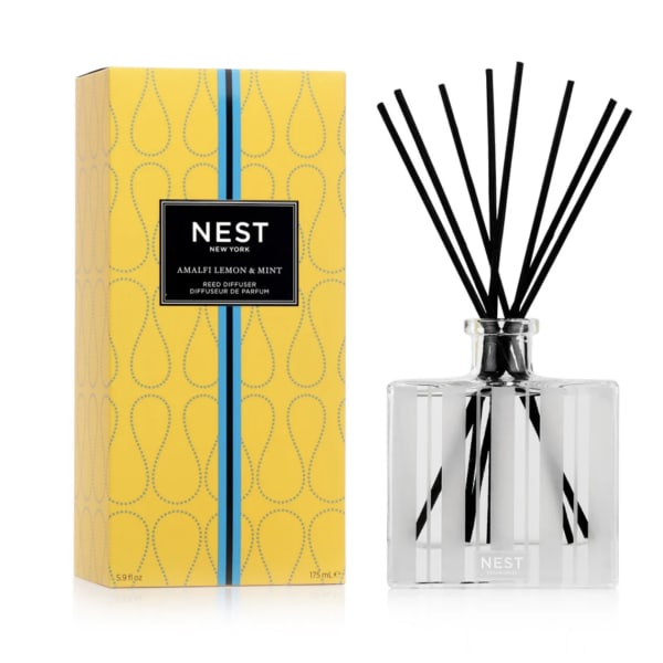 Yellow boxed NEST reed diffuser with clear glass bottle and black fragrance reeds.