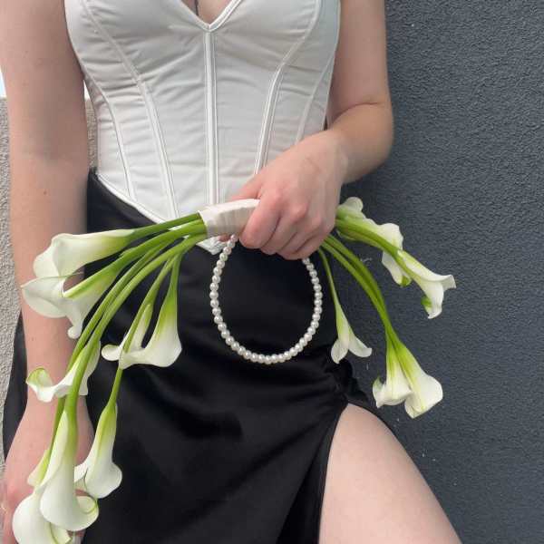 Woman holding a bouquet of white calla lilies