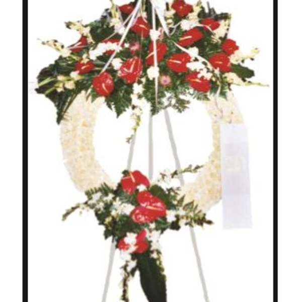 Standing funeral spray with red and white flowers on an easel