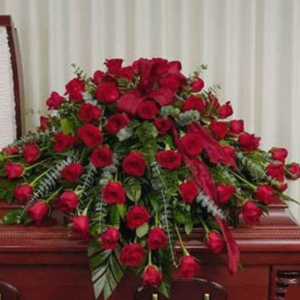 Large spray of red roses on a casket