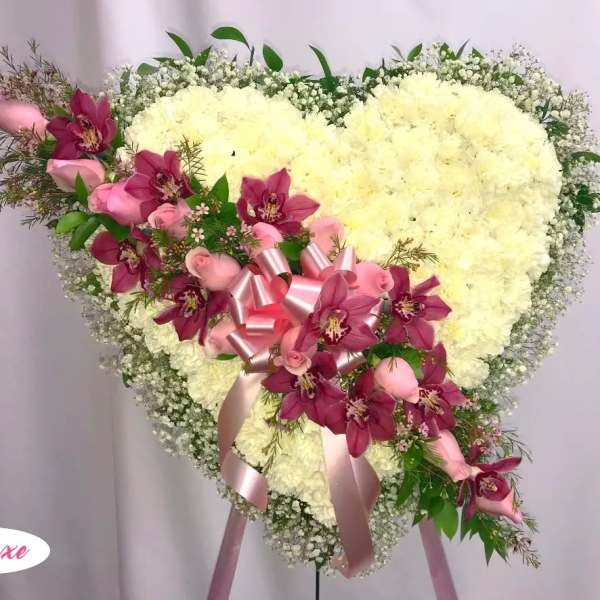 Heart-shaped floral spray with white blooms and pink orchids