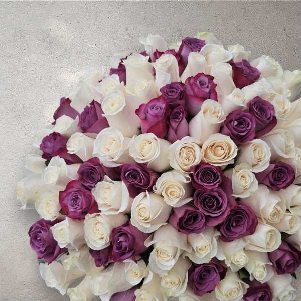 Bouquet of white and purple roses tightly packed together