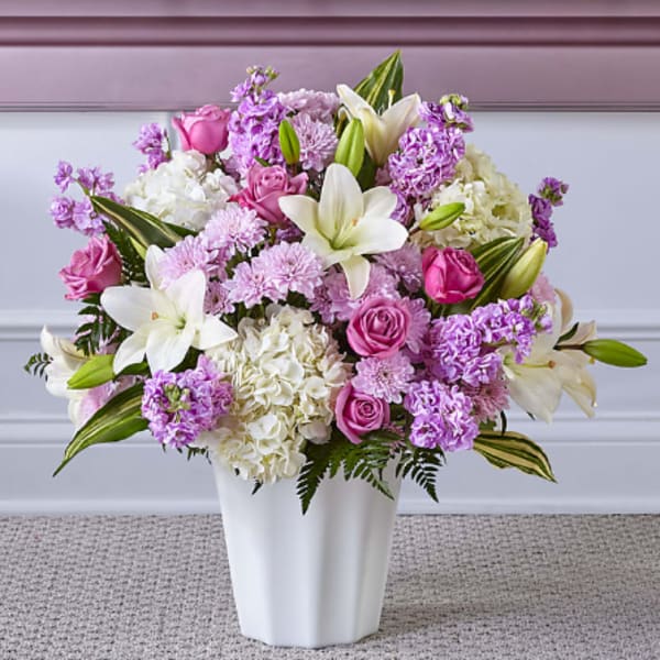Pink and white mixed flower arrangement in a white vase