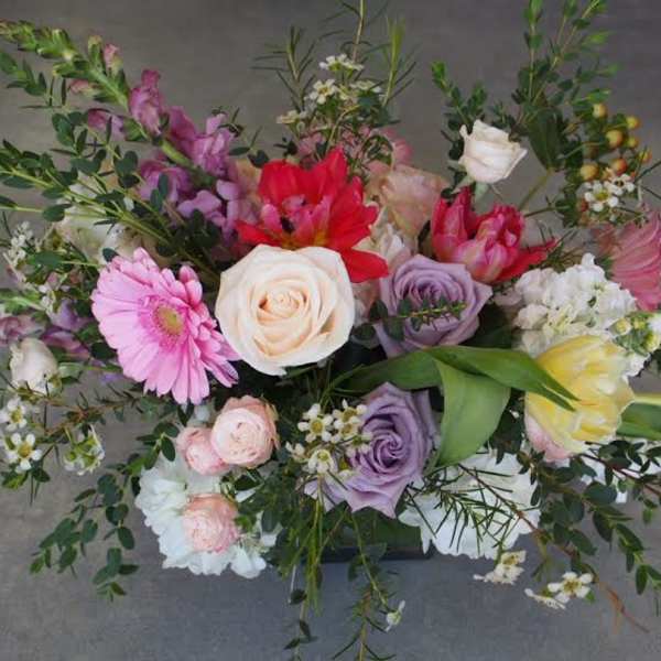 Mixed bouquet with roses, tulips, and gerbera daisies in pink, white, purple, and yellow