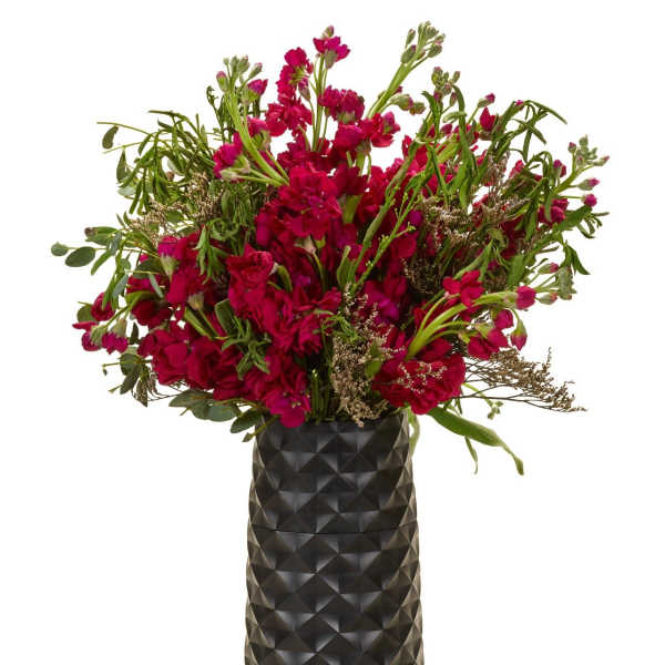 Magenta flower arrangement in a tall black vase