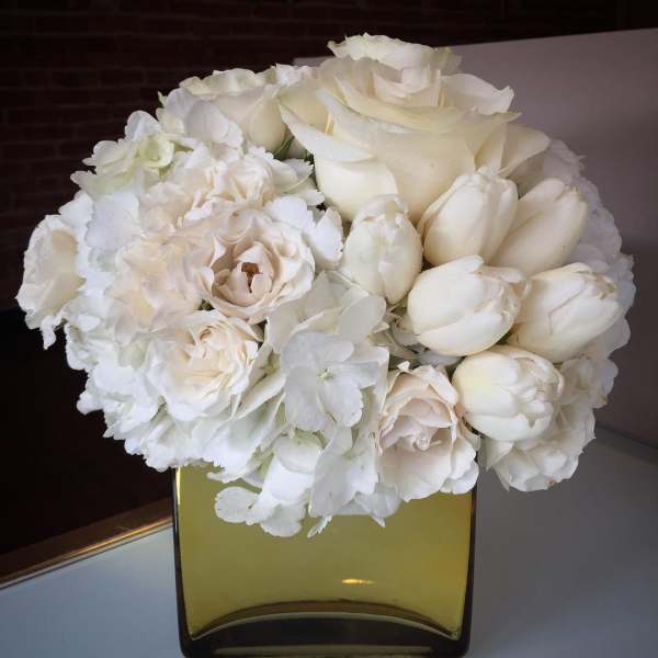 White rose and tulip bouquet in a square glass vase