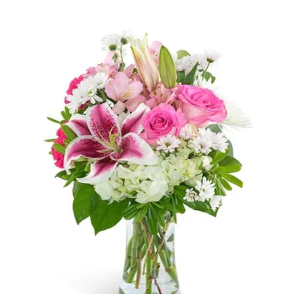 Pink and white mixed bouquet in a clear glass vase