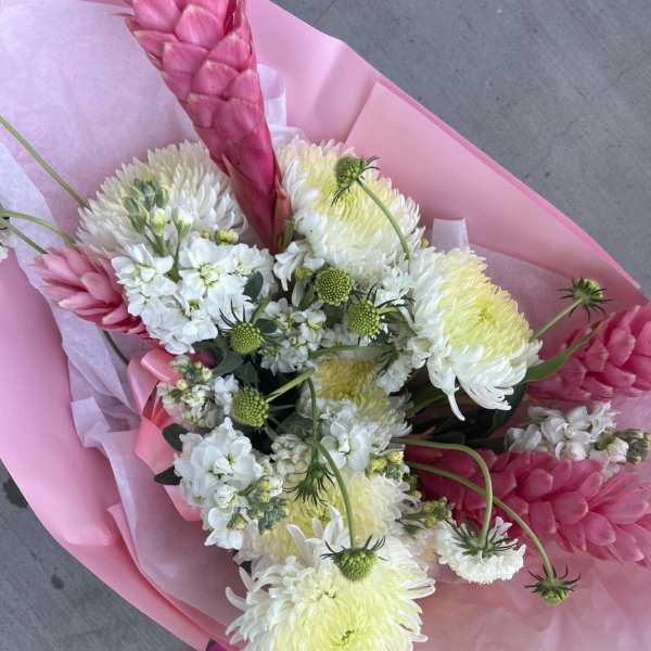 Pink and white bouquet with large chrysanthemum blooms and pink tropical flowers