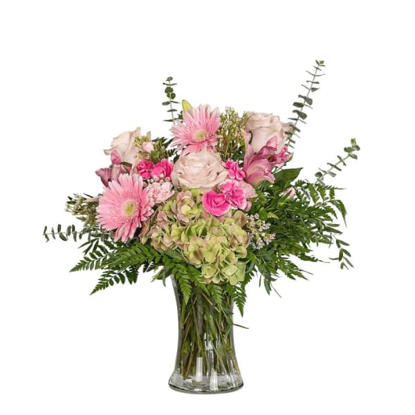 Pink and white mixed flowers in a clear glass vase