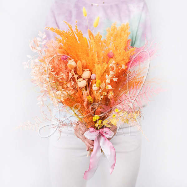 Bright orange and pink dried bouquet tied with a pink ribbon