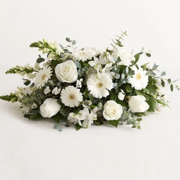 White roses and daisy-like flowers in a low arrangement