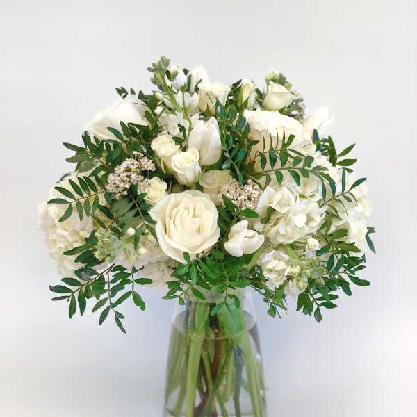 White rose bouquet in a clear glass vase