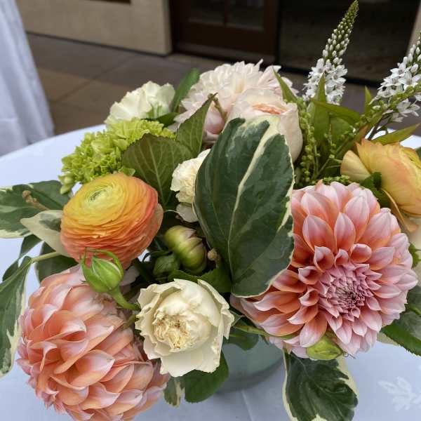Pastel bouquet with pink dahlias, ranunculus, and white blooms in a vase