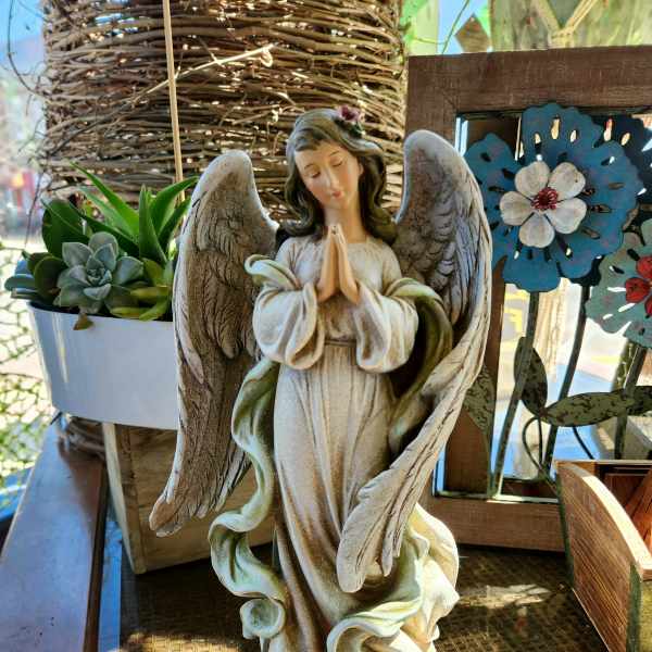 Angel figurine beside a small succulent planter