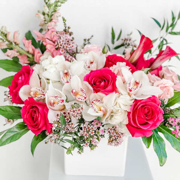Pink and white floral arrangement in a white vase