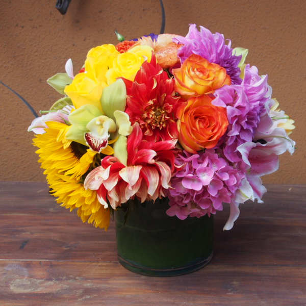 Colorful mixed bouquet in a dark glass vase