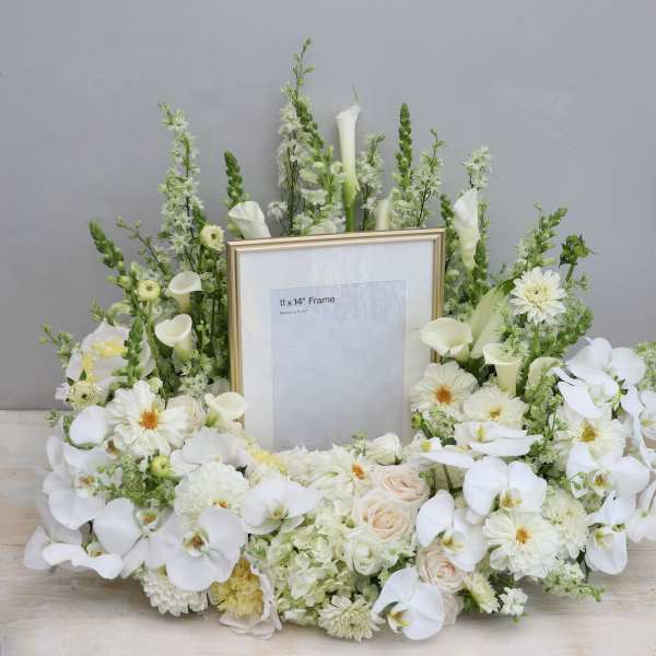 White floral frame arrangement with orchids and calla lilies