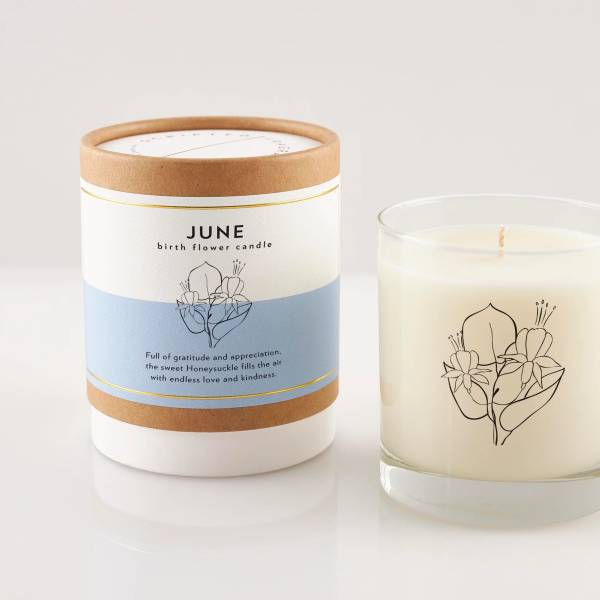 Two June birth flower candles, one in a box and one in a glass jar