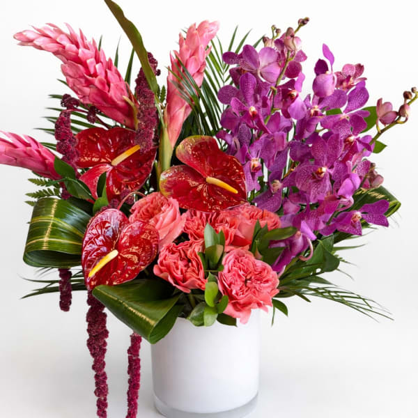 Pink and purple tropical bouquet in a white vase