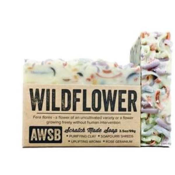 Rustic bar of wildflower-scented soap with colorful shreds and kraft paper label