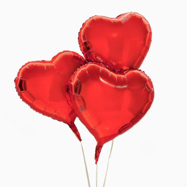 Three red heart-shaped balloons on sticks