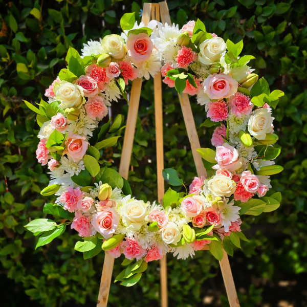 Pink and white standing funeral wreath