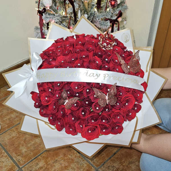 Large red rose bouquet with a birthday ribbon and butterfly decorations