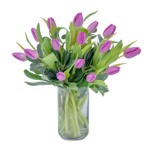 Purple tulip bouquet arranged in a clear glass cylinder vase