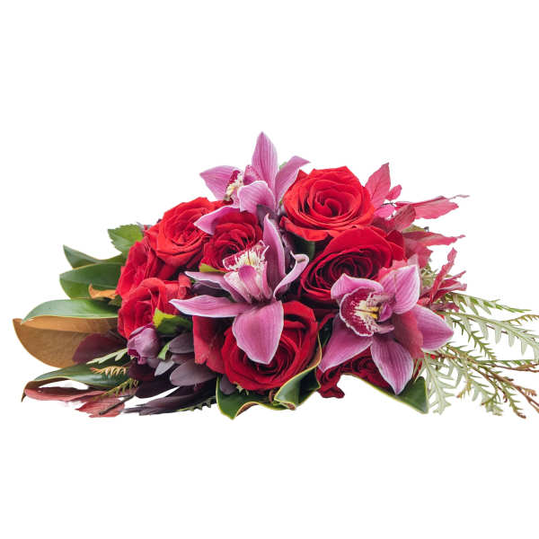 Hand-tied bouquet of red roses and pink orchids arranged in a compact cluster