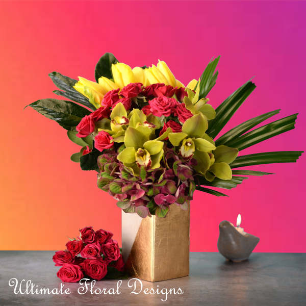 Bouquet of red roses and yellow orchids in a gold vase