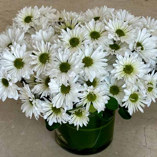 White daisy bouquet in a green glass vase