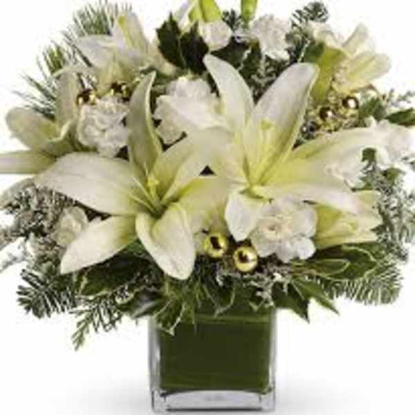 White lilies and white flowers in a square glass vase