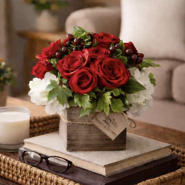 Red roses and white hydrangeas in a rustic wooden box