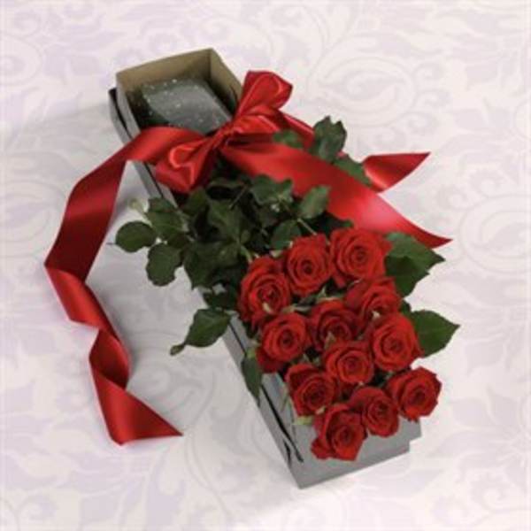 Red roses in a rectangular gift box with a red ribbon