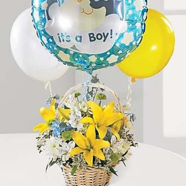 Yellow and white flower basket with it’s a boy balloon and colored balloons behind