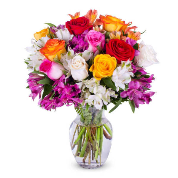 Colorful bouquet of roses and alstroemeria in a clear glass vase