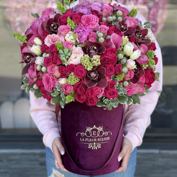 Large pink and burgundy bouquet in a purple hatbox