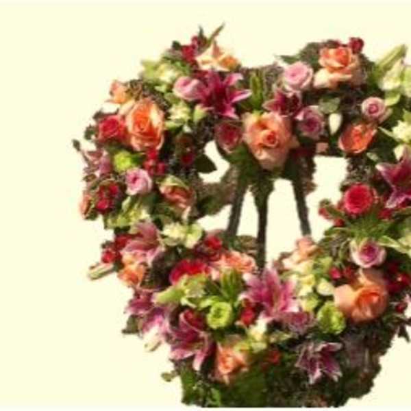 Heart-shaped floral wreath with pink, orange, and purple flowers