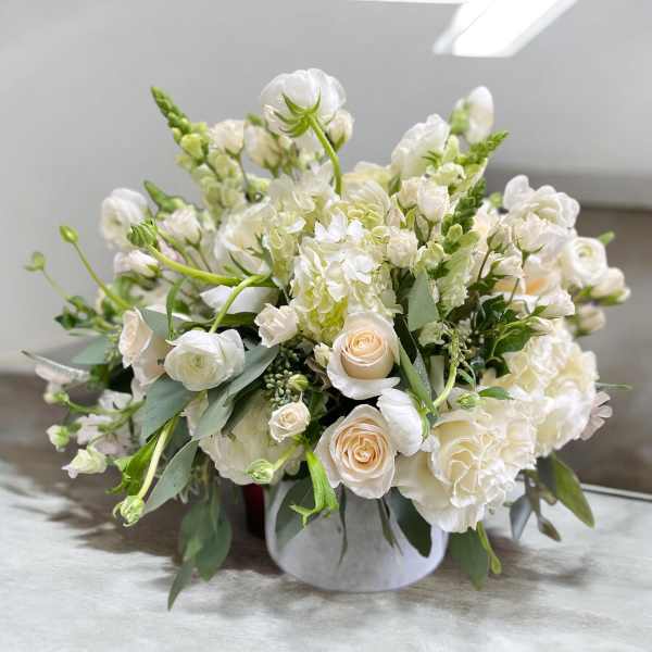 White floral arrangement in a low round vase