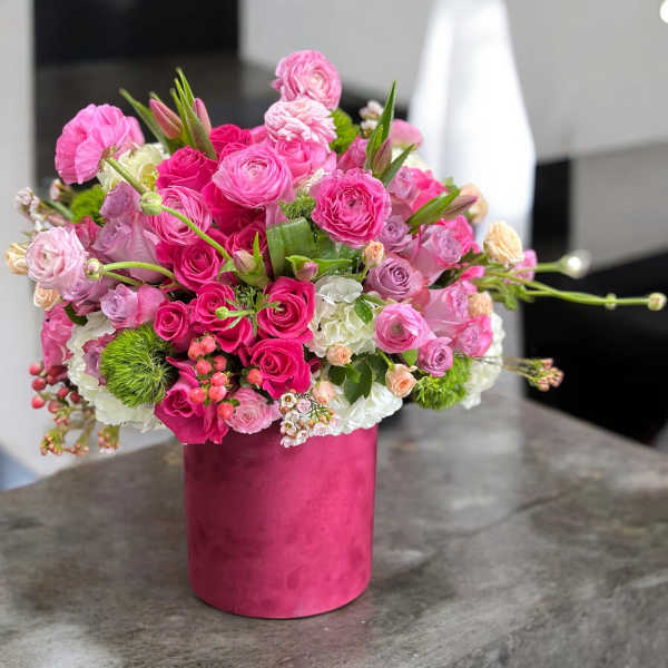 Pink and white bouquet in a magenta vase