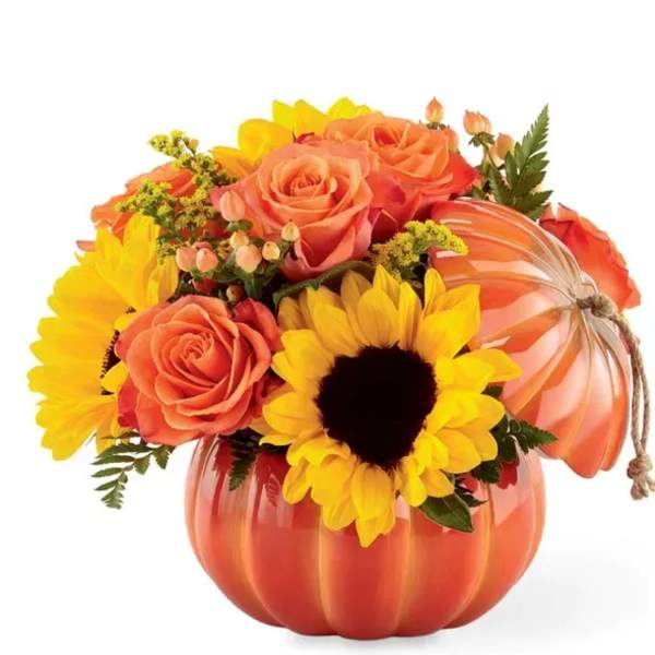 Orange pumpkin-shaped container with roses and sunflowers