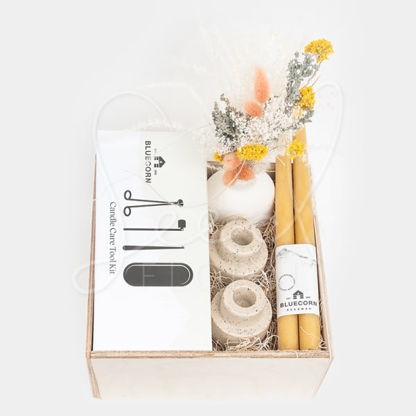 Gift box with candles, candle tools, and dried flowers