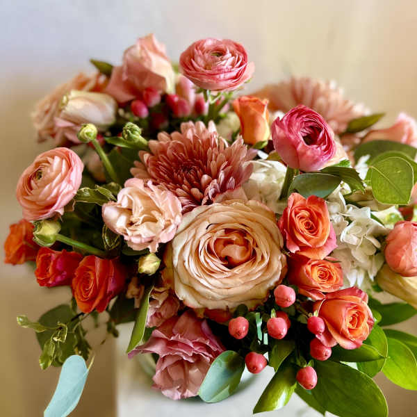 Bouquet of pink and peach flowers with roses and ranunculus