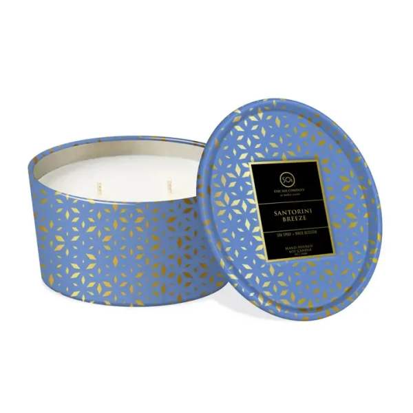 Blue patterned candle tin with lid beside an open candle container