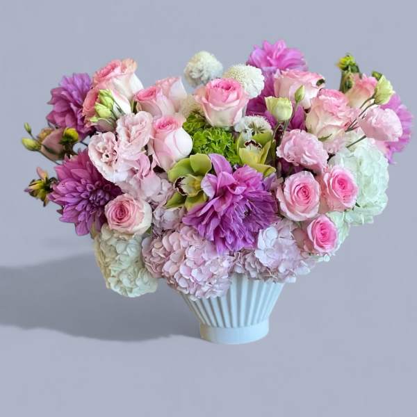 Pink and purple mixed bouquet in a white vase