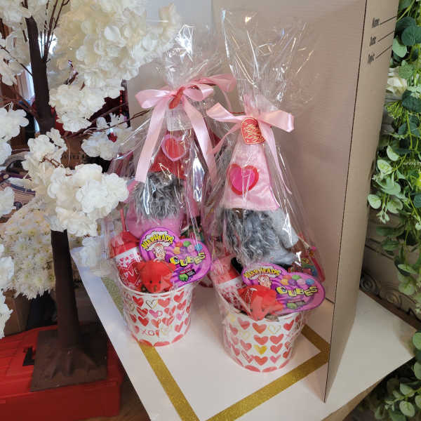 Two Valentine gift baskets with candy and plush gnomes