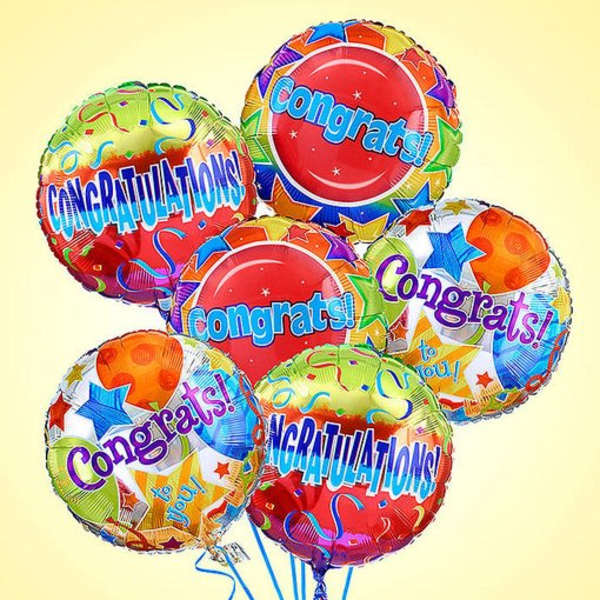 Cluster of colorful congratulatory balloons with star patterns