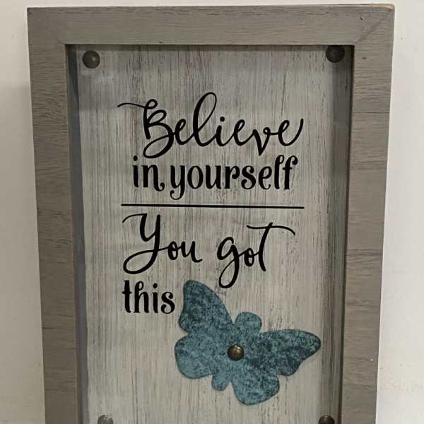 Framed rustic sign with “Believe in yourself You got this” text and a teal butterfly accent.
