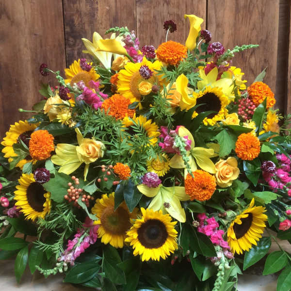 Large mixed bouquet with sunflowers, yellow lilies, and orange blooms